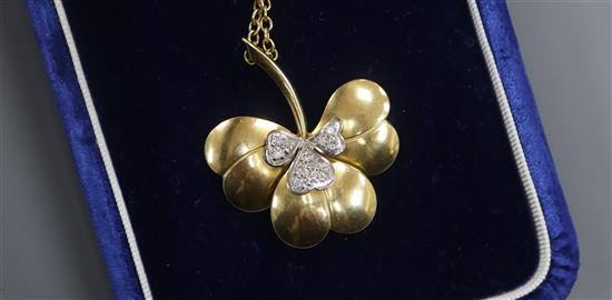 A modern 18ct gold and diamond set leaf pendant, on an 18ct gold chain, in Garrard & Co box, pendant 38mm.